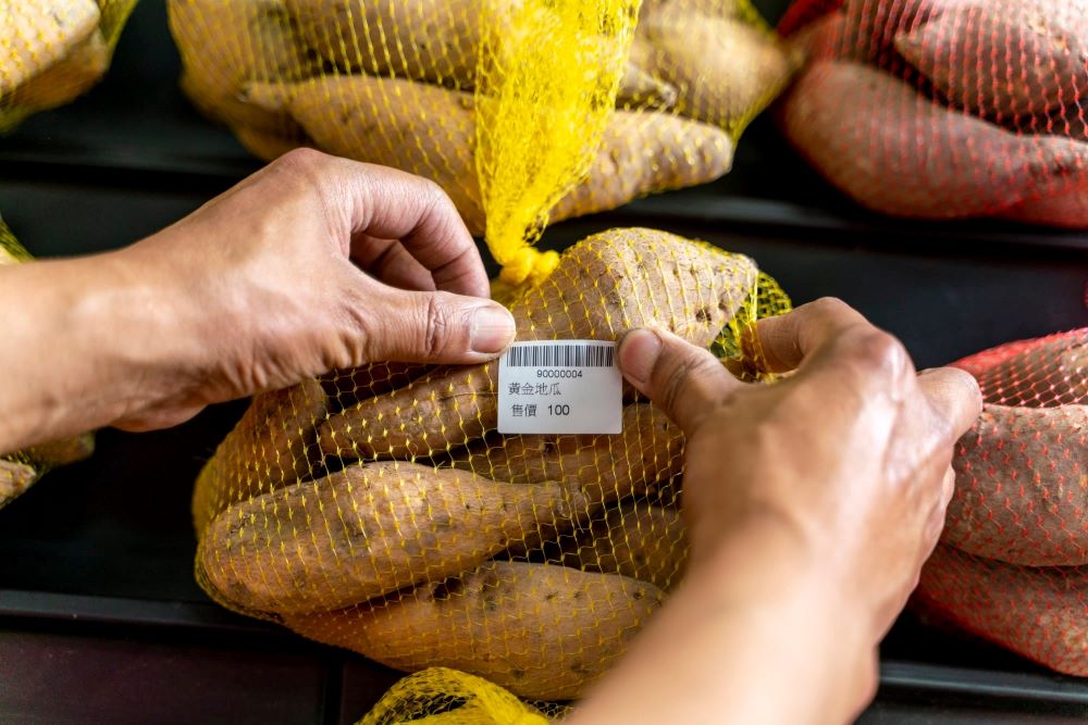 農民直銷站店長印出價格標籤,由農友自己上架。